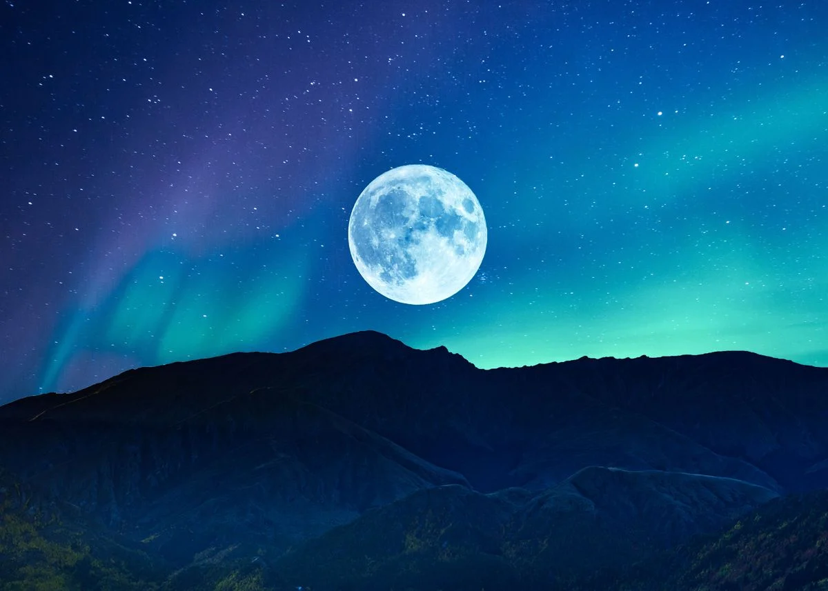 A full moon in the horizon with blue and green aurora lights 