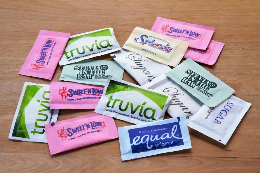 Various Artificial Sweeteners placed on wooden surface