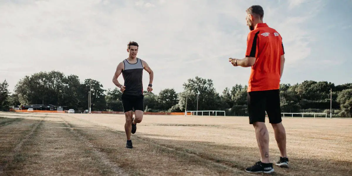A running coach training a runner
