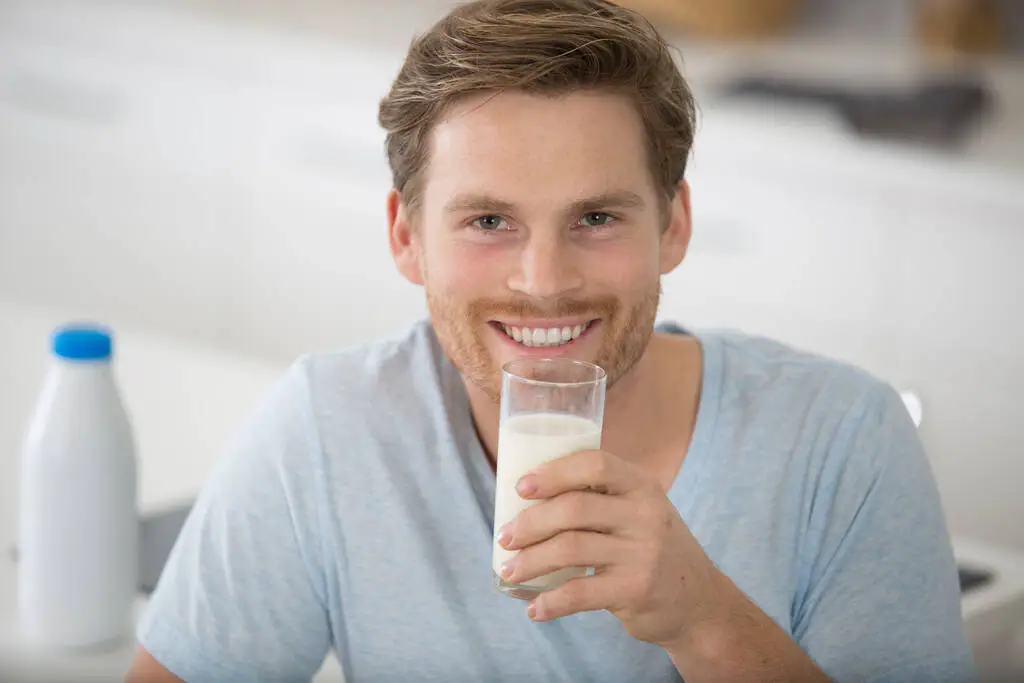 A man holding a glass of milk