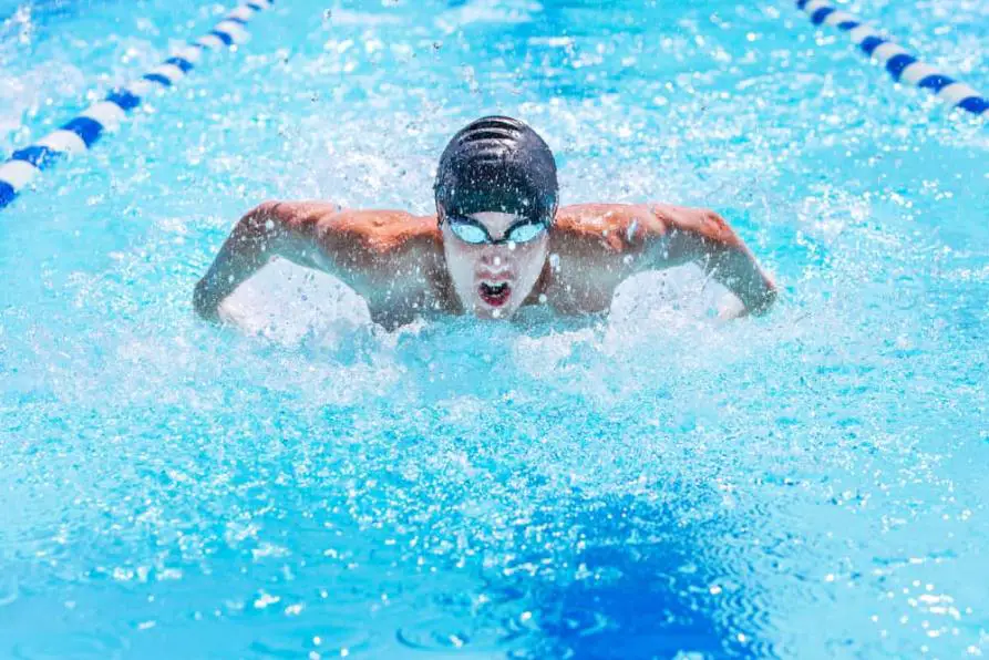 A swimmer is swimming butterfly stroke in a race