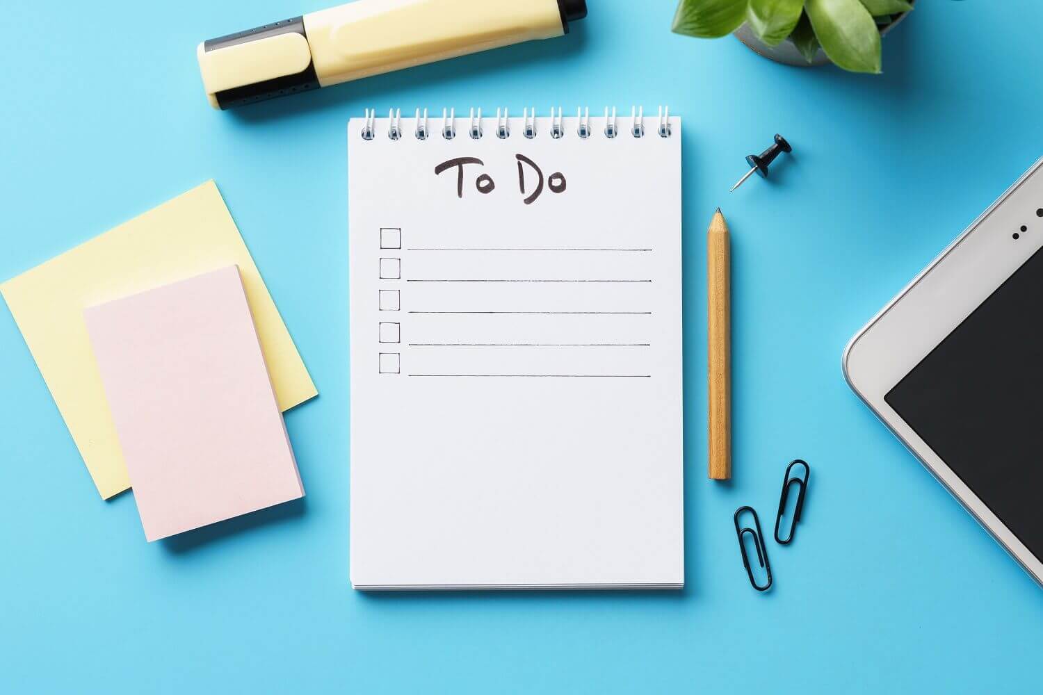Notepad with Writing Essentials around it