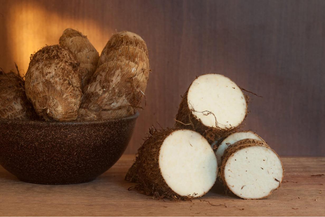 Yams—some placed in a bowl, others placed outside on a wooden surface