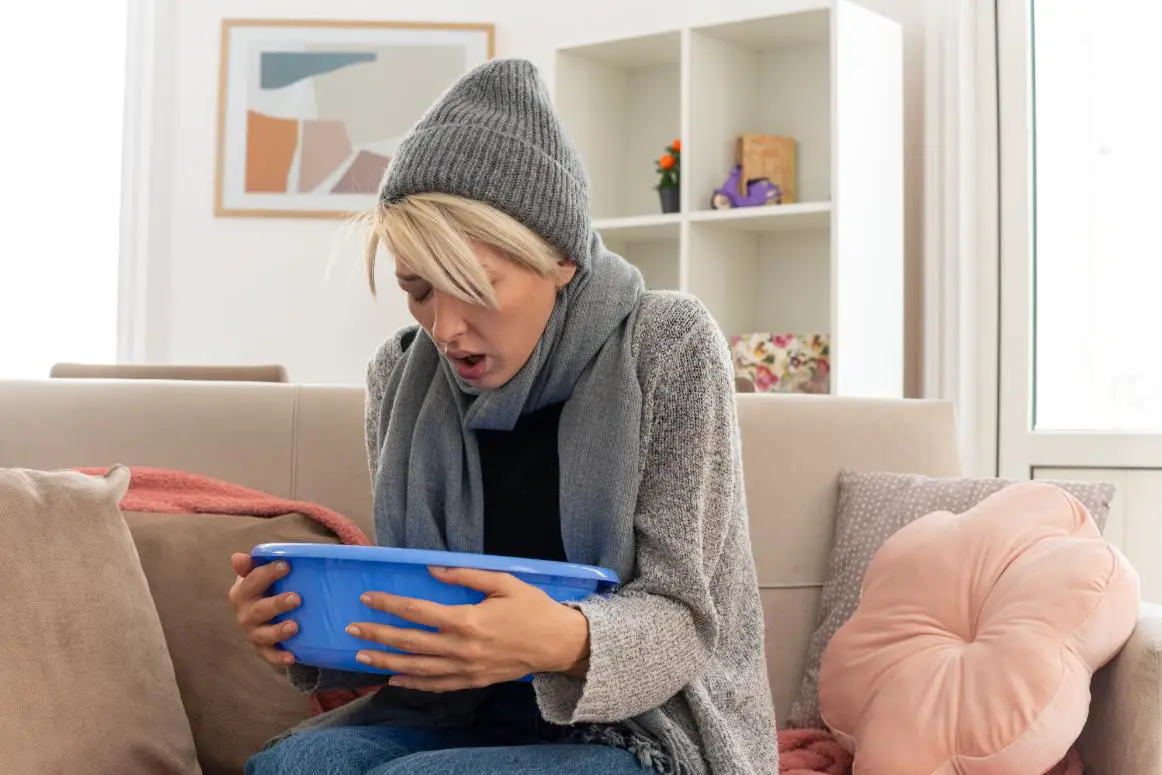 A Young Sick Nauseous Girl with scarf around her head and wearing a winter hat holding a basket in her living room