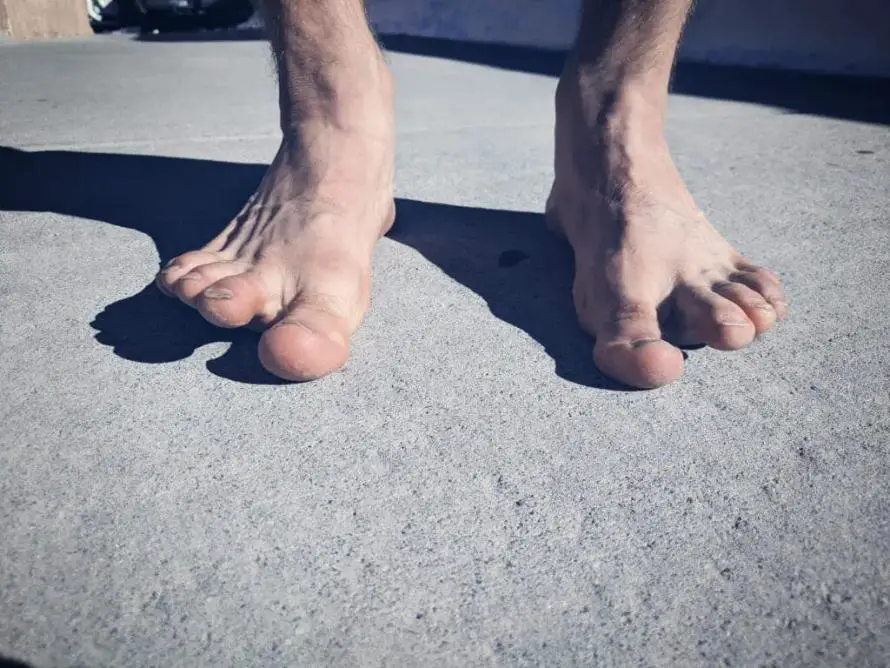 Barefooted male on a concrete surface.