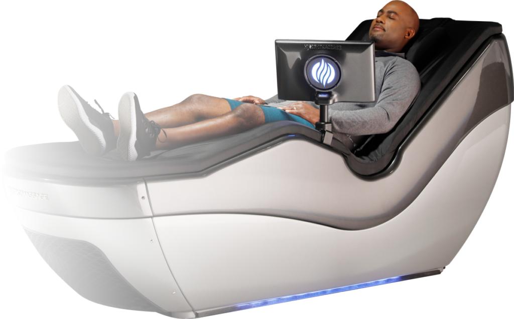 A bald man enjoying a massage on a hydromassage bed.
