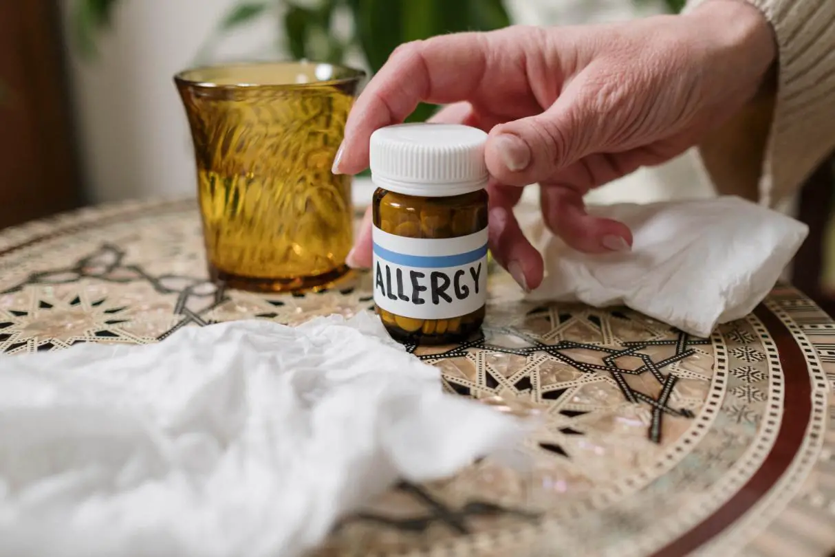 A hand getting towards anti-allergy medication