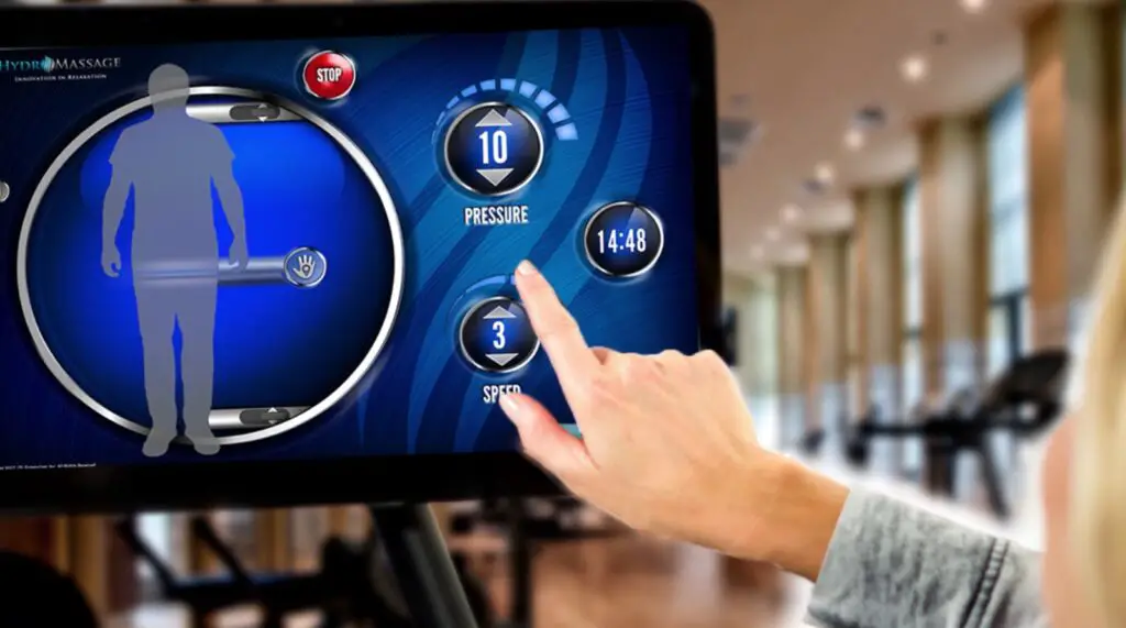 A woman hand setting massage controls