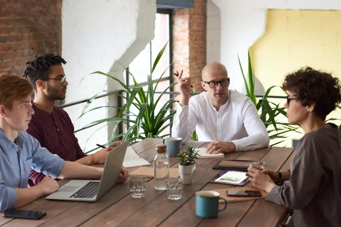 A group of people in a meeting, working together as a team