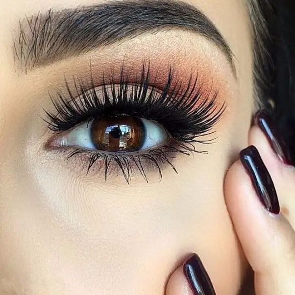 Close-up image of a woman's eye with glamorous eye makeup