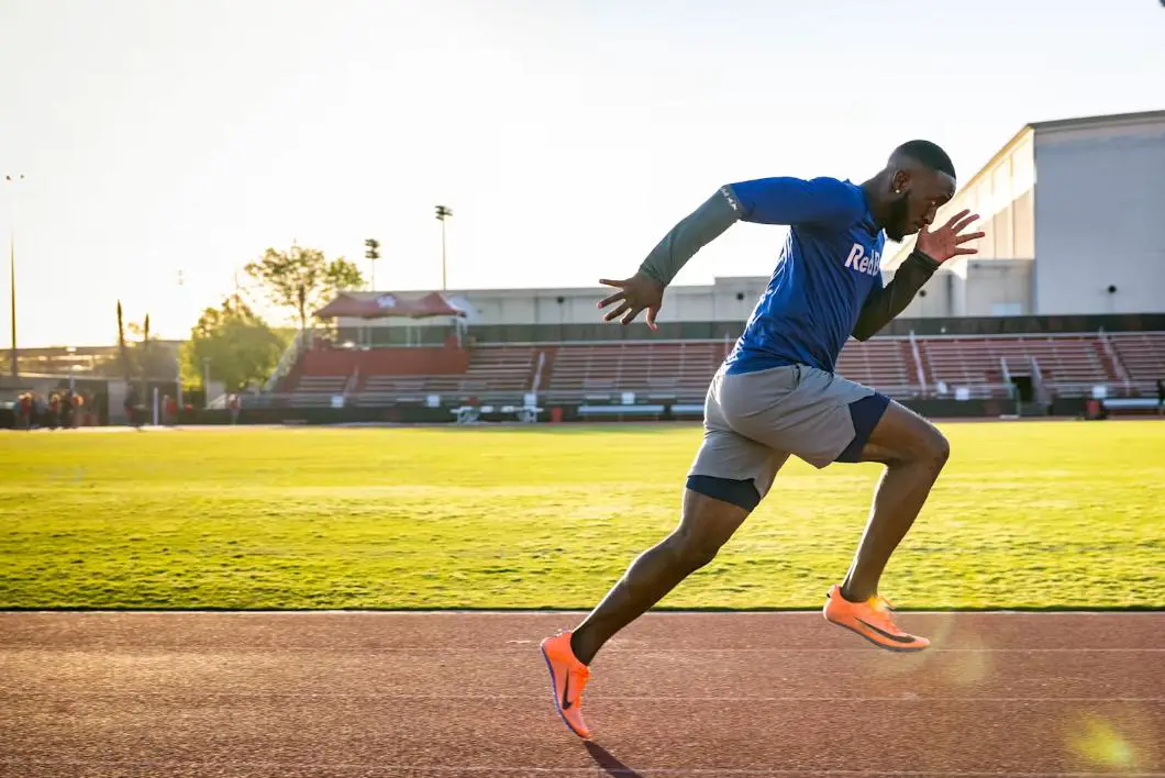 An athlete running in a stadium 