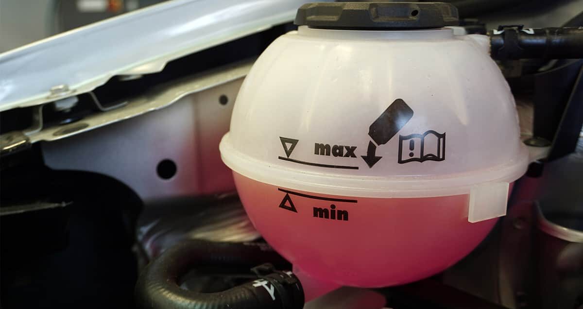 Car interior; coolant reservoirs with coolant level at half capacity. 