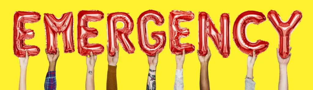 Multiple hands holding balloons, each shaped like a letter, spelling out "EMERGENCY" against a yellow background.
