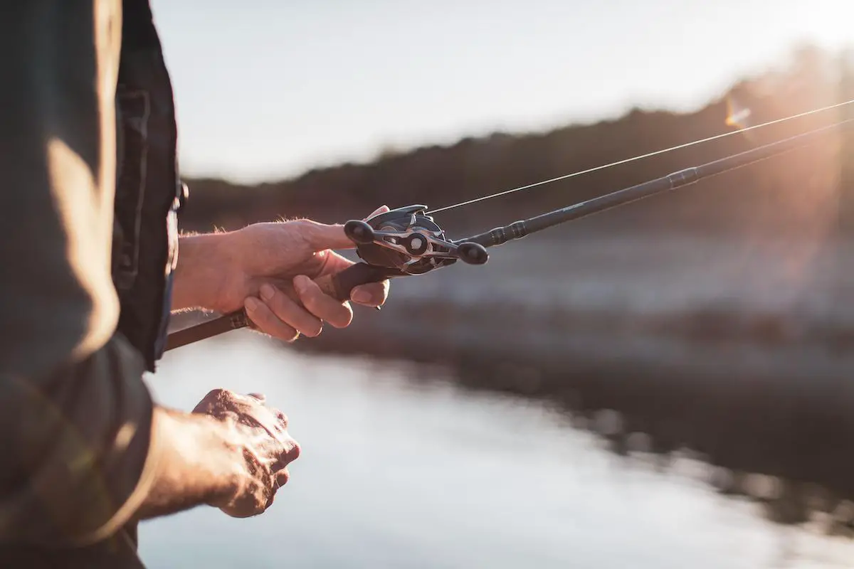 Close-up image of a person holding a fishing line.