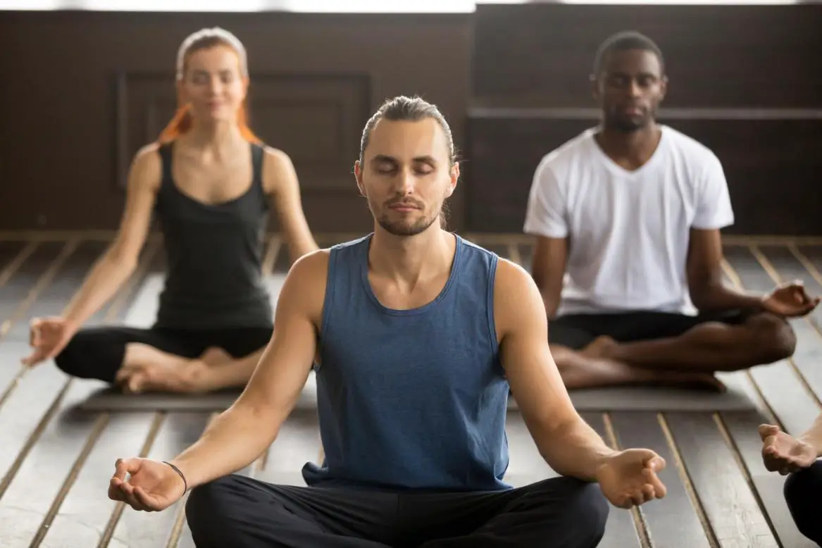 group of 3 young people busy in their meditation