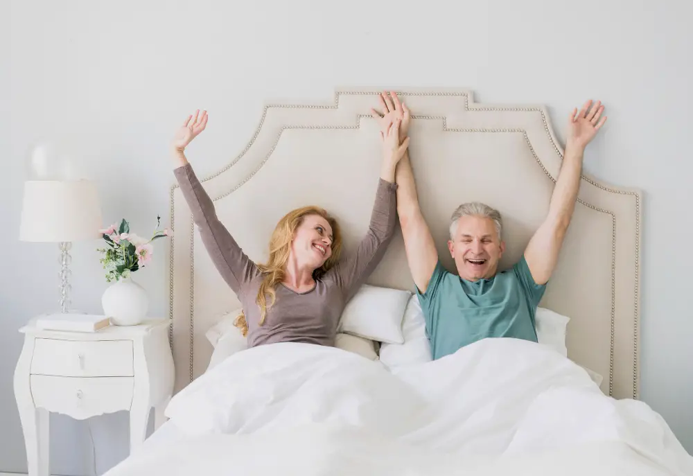 Happy senior man and woman after a good sleep on an adjustable bed