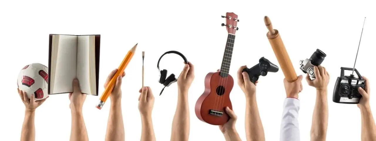 Multiple hands enthusiastically holding various items, showcasing individual interests and passions.