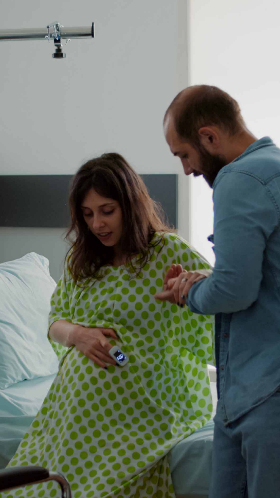 Husband helping her pregnant wife to sit
