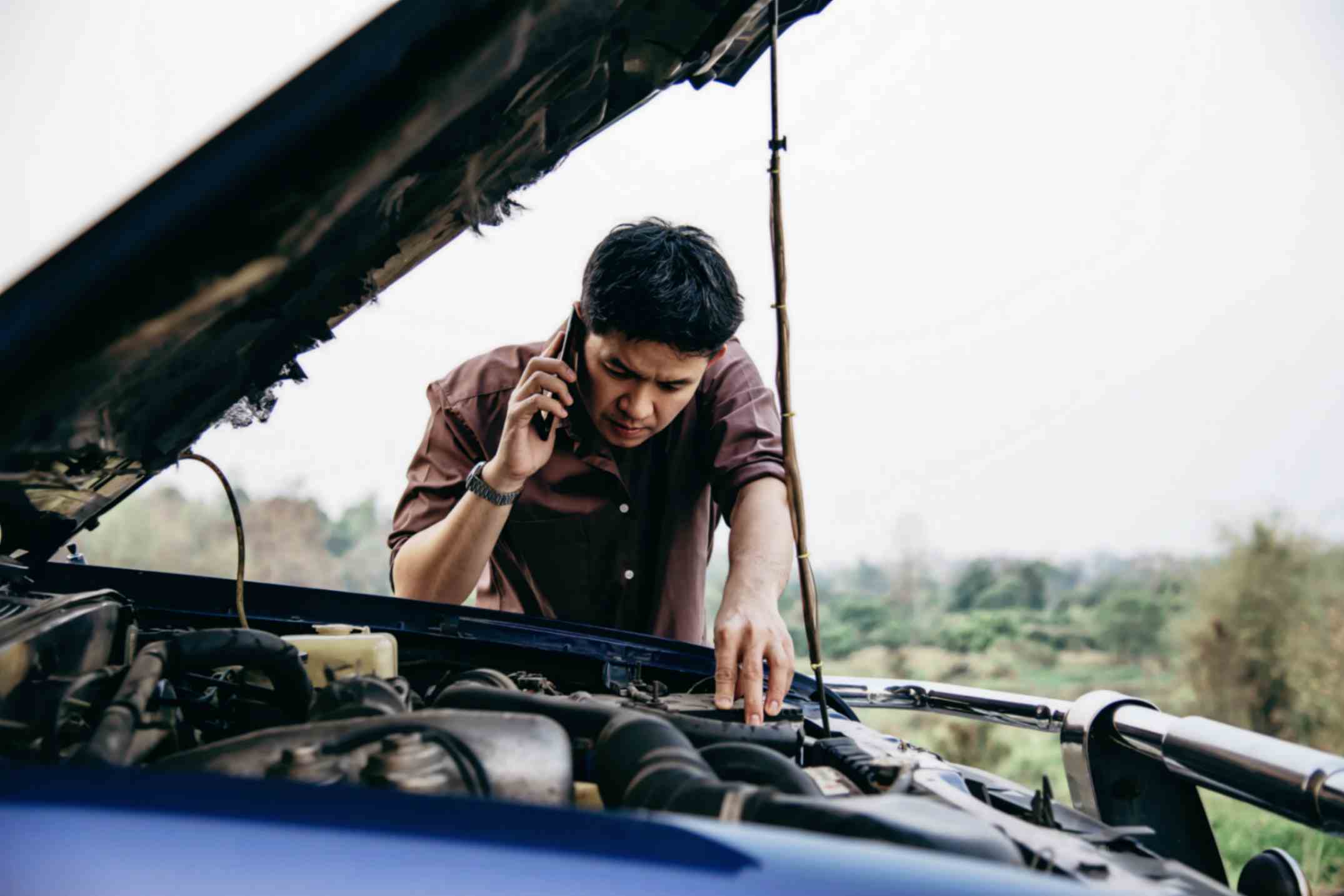 Man Try to Fix Car on The Road