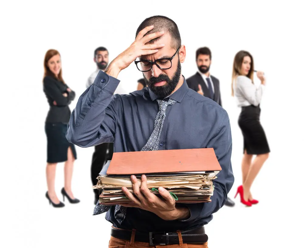 Man is holding pile of files and is worried due to workload