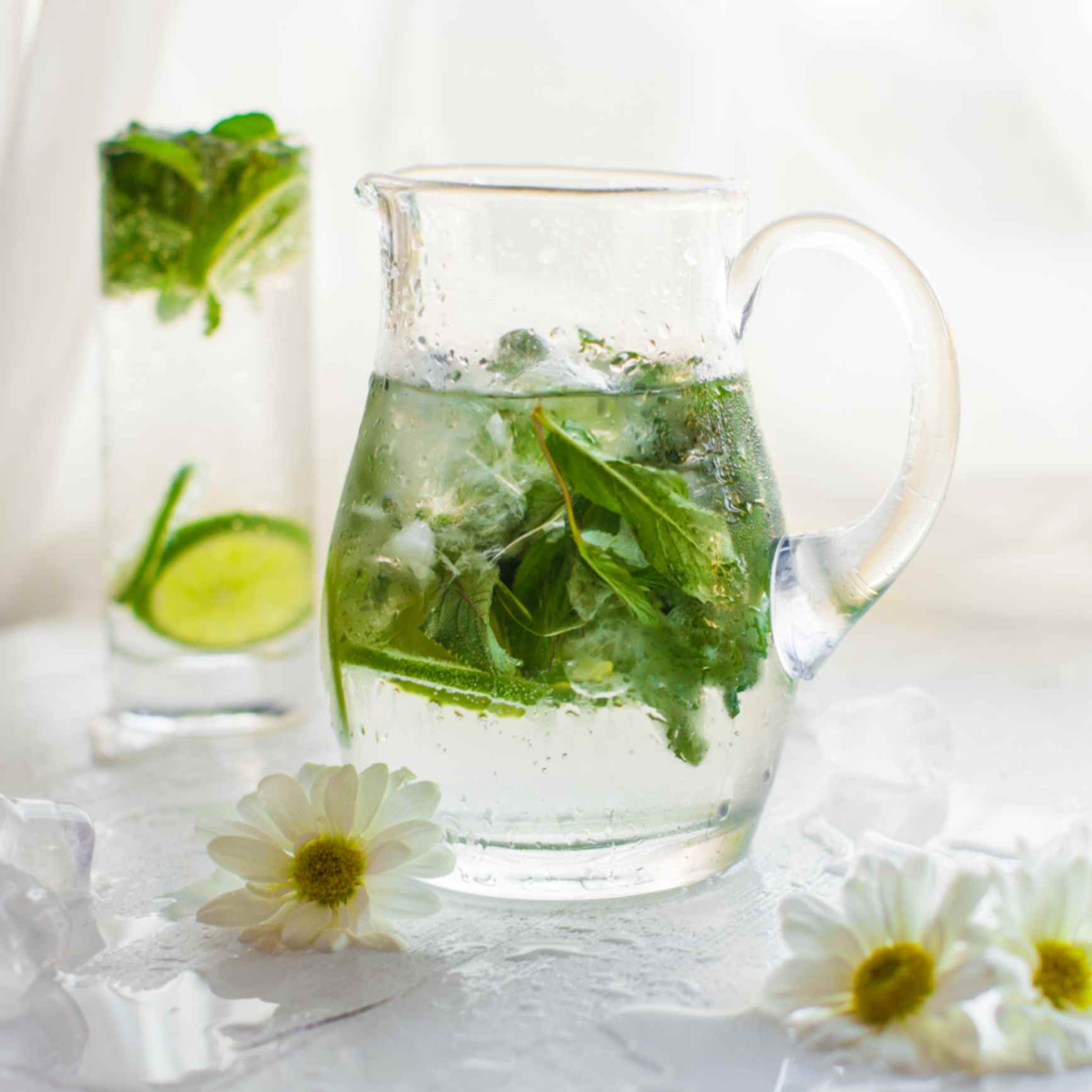 A jar and a glass containing mint water