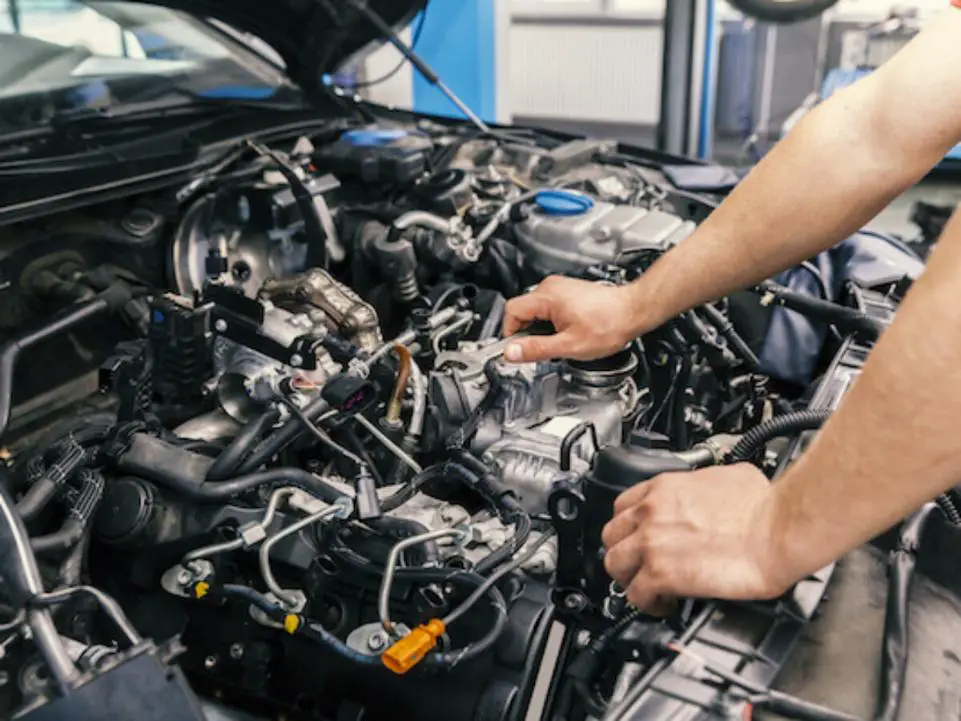 A man inspecting the engine bay