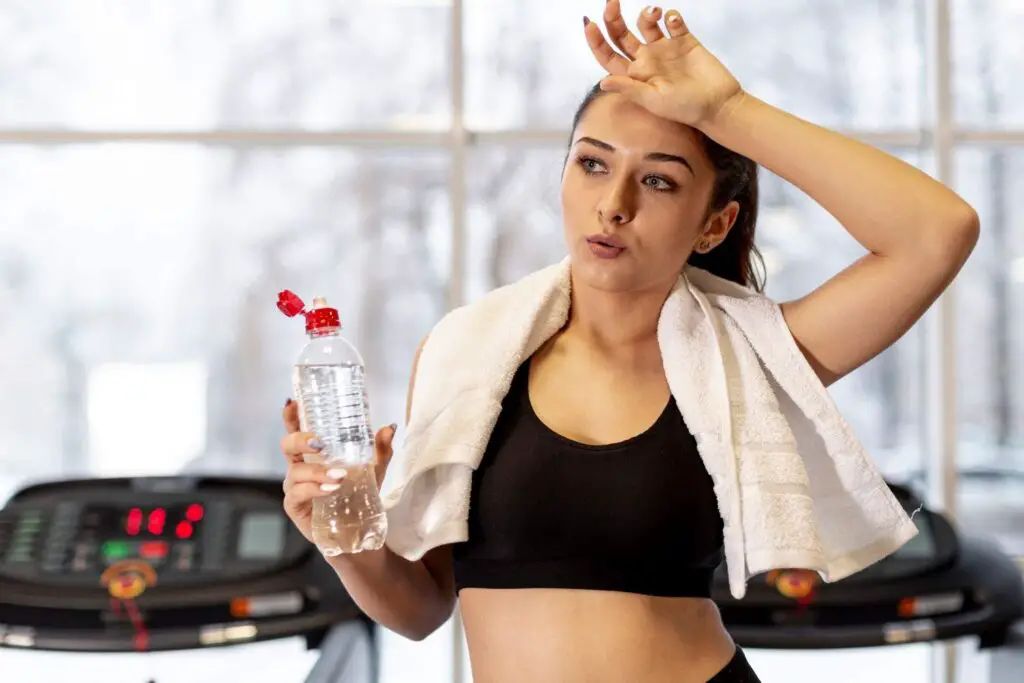 Working Women Drinking Water After Working Out 
