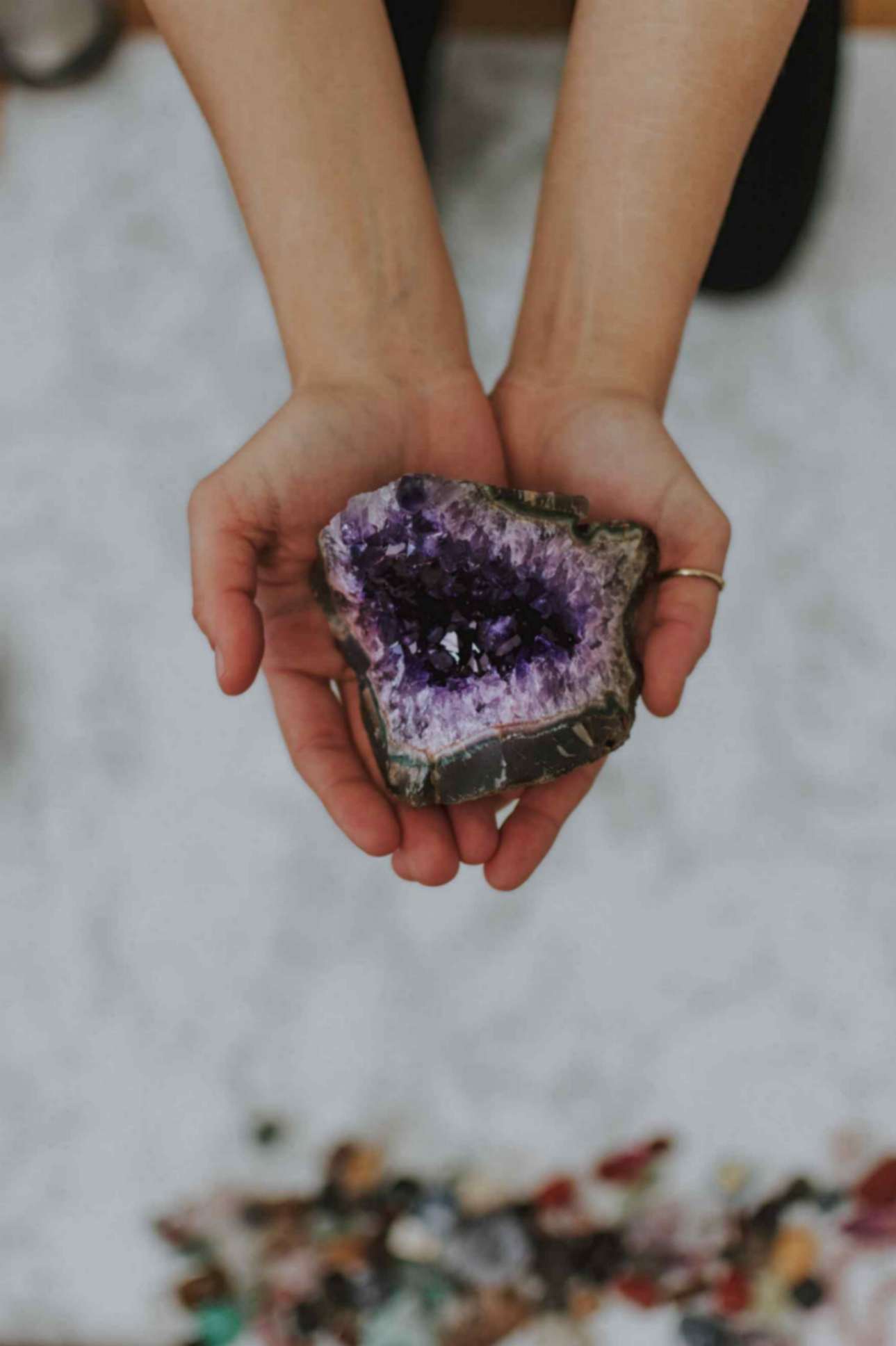 Woman Holding Multicolored Rock in Her Hand
