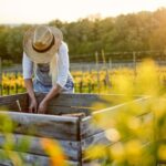 Woman with hat working in Raised Garden