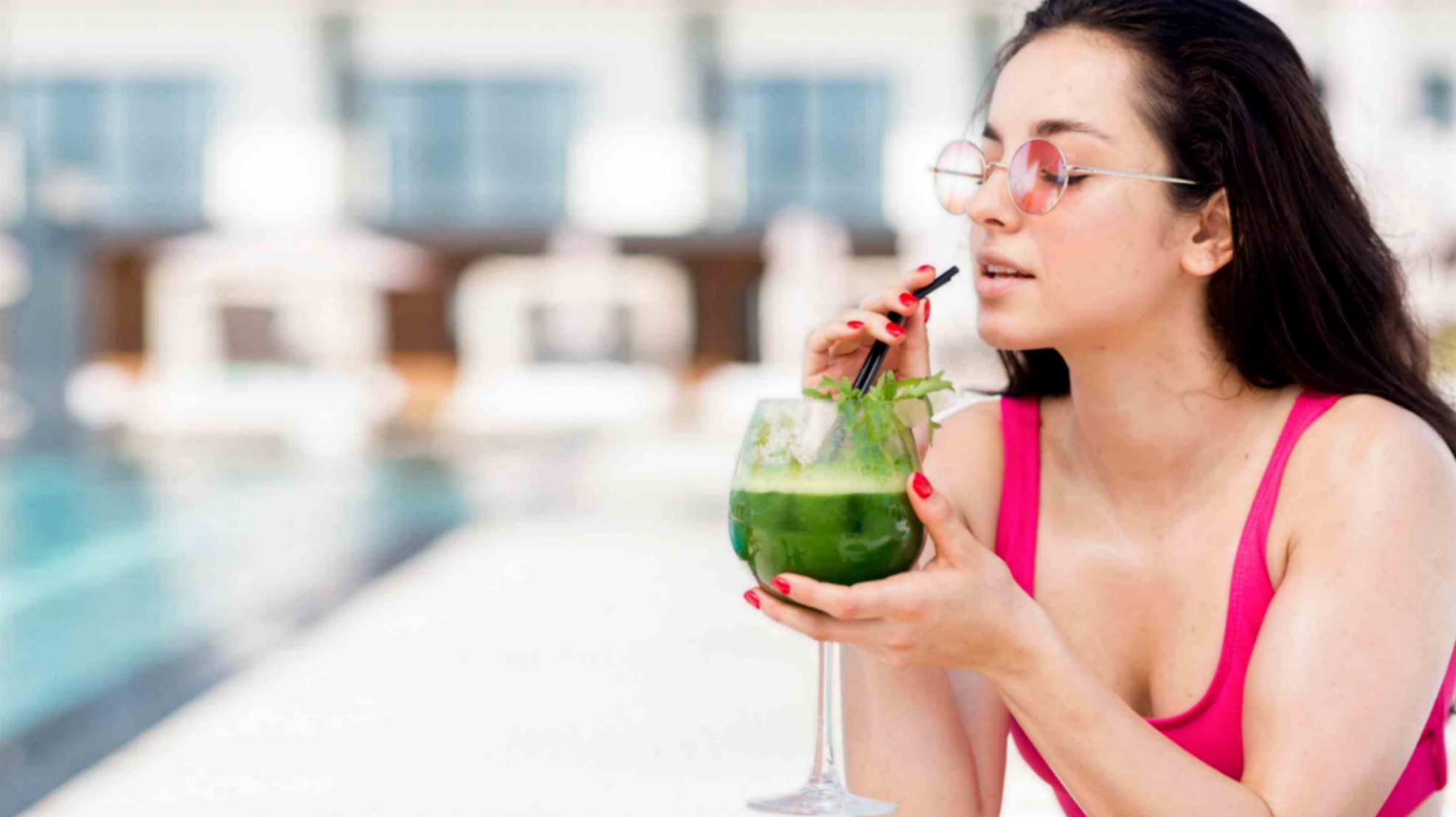 Women Enjoying Green Juice Near the Pool