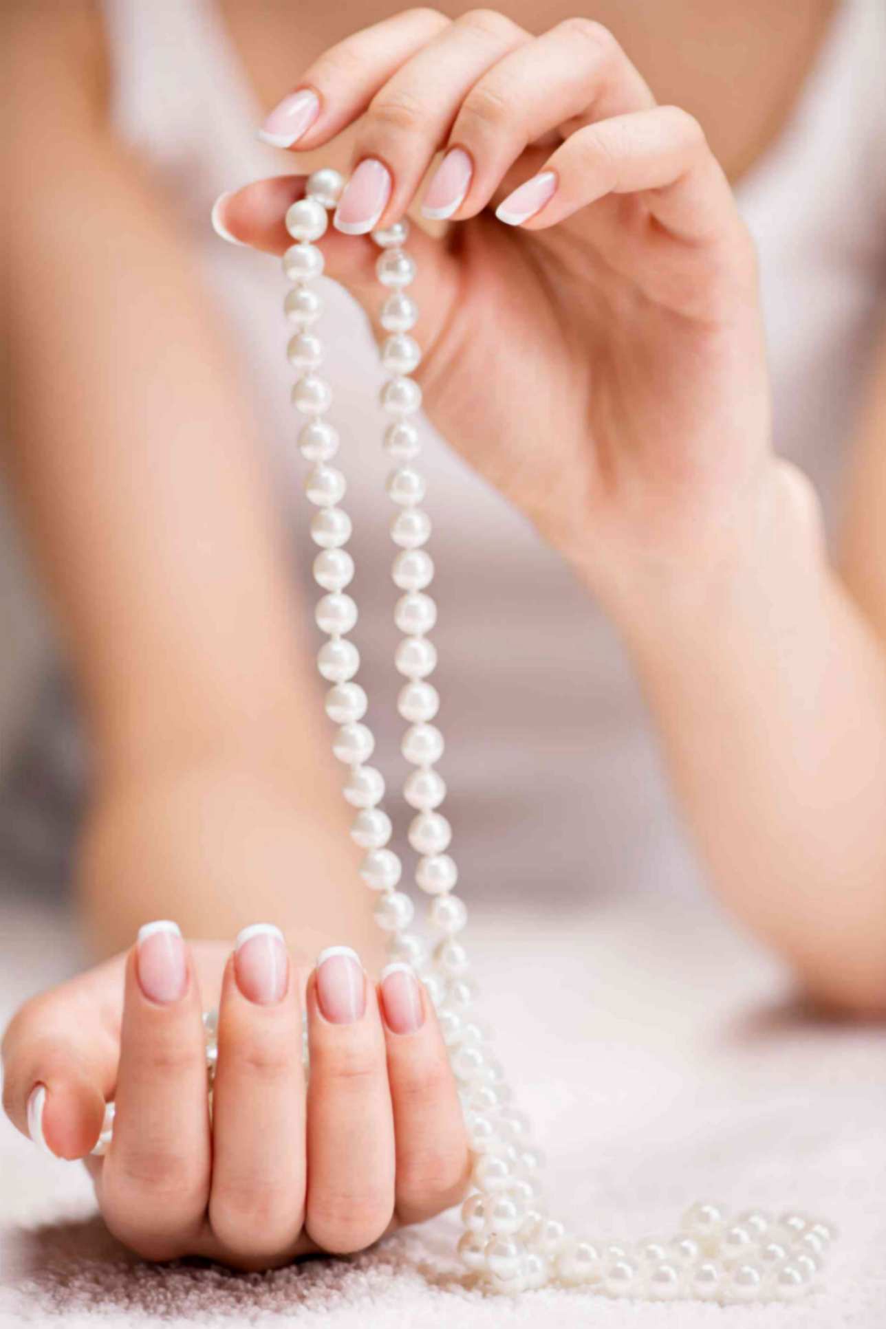 Women Holding Beautiful White Pearl Necklace