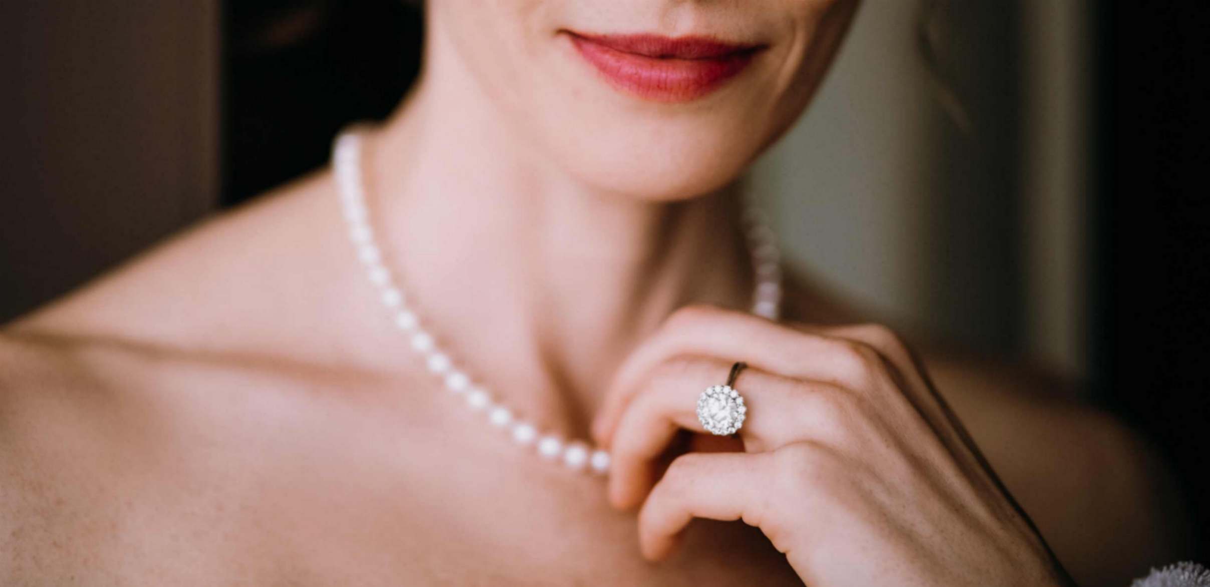 Women is Touching Her Pearl Necklace