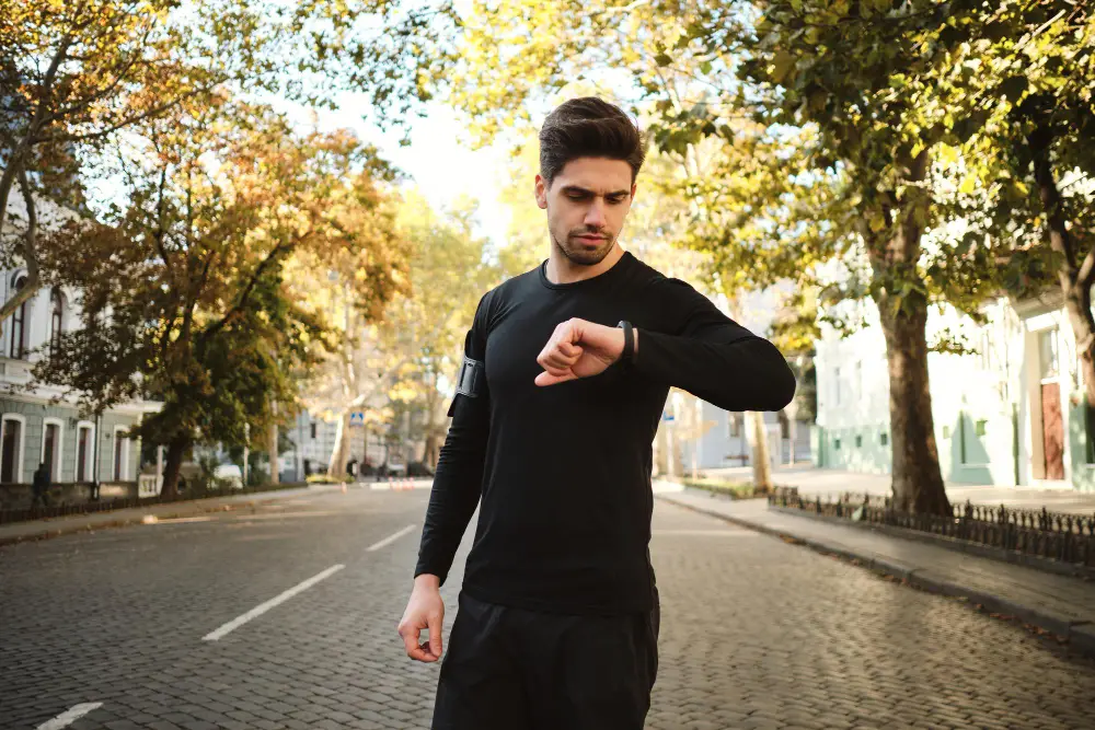 Young Man Checking his Watch after Interval Running