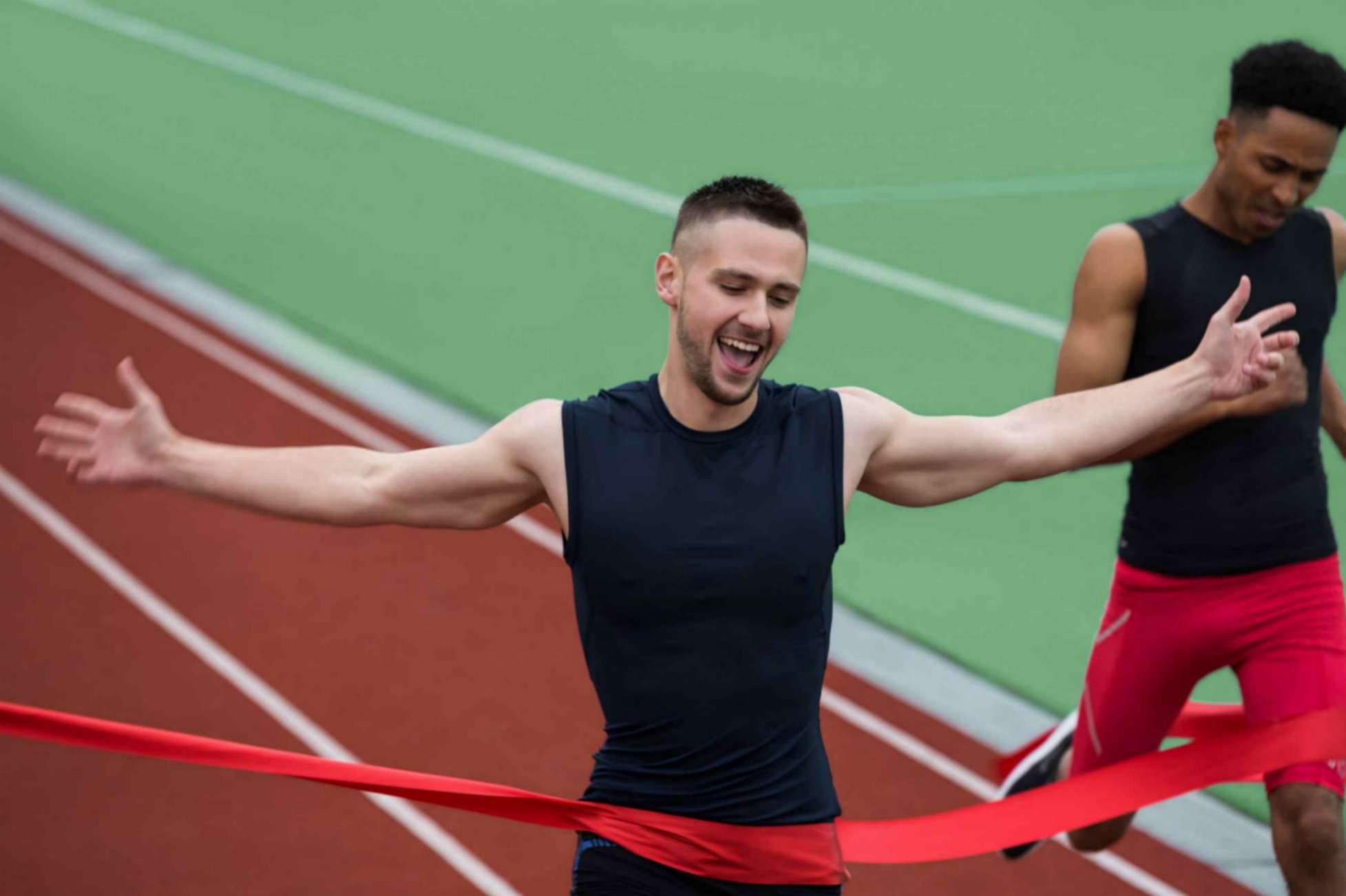 Young Men Cheerfully Crossing The Finish Line