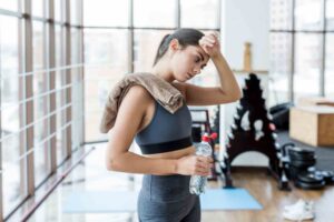 Young Woman Wiping Herself After Workout