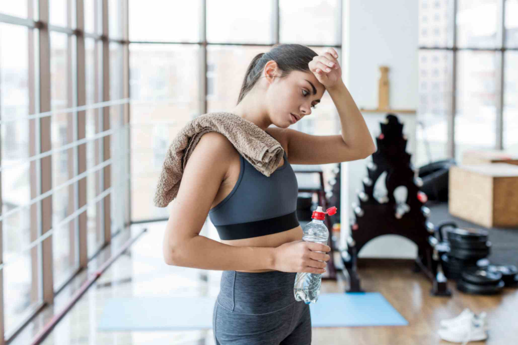 Young Woman Wiping Herself After Workout