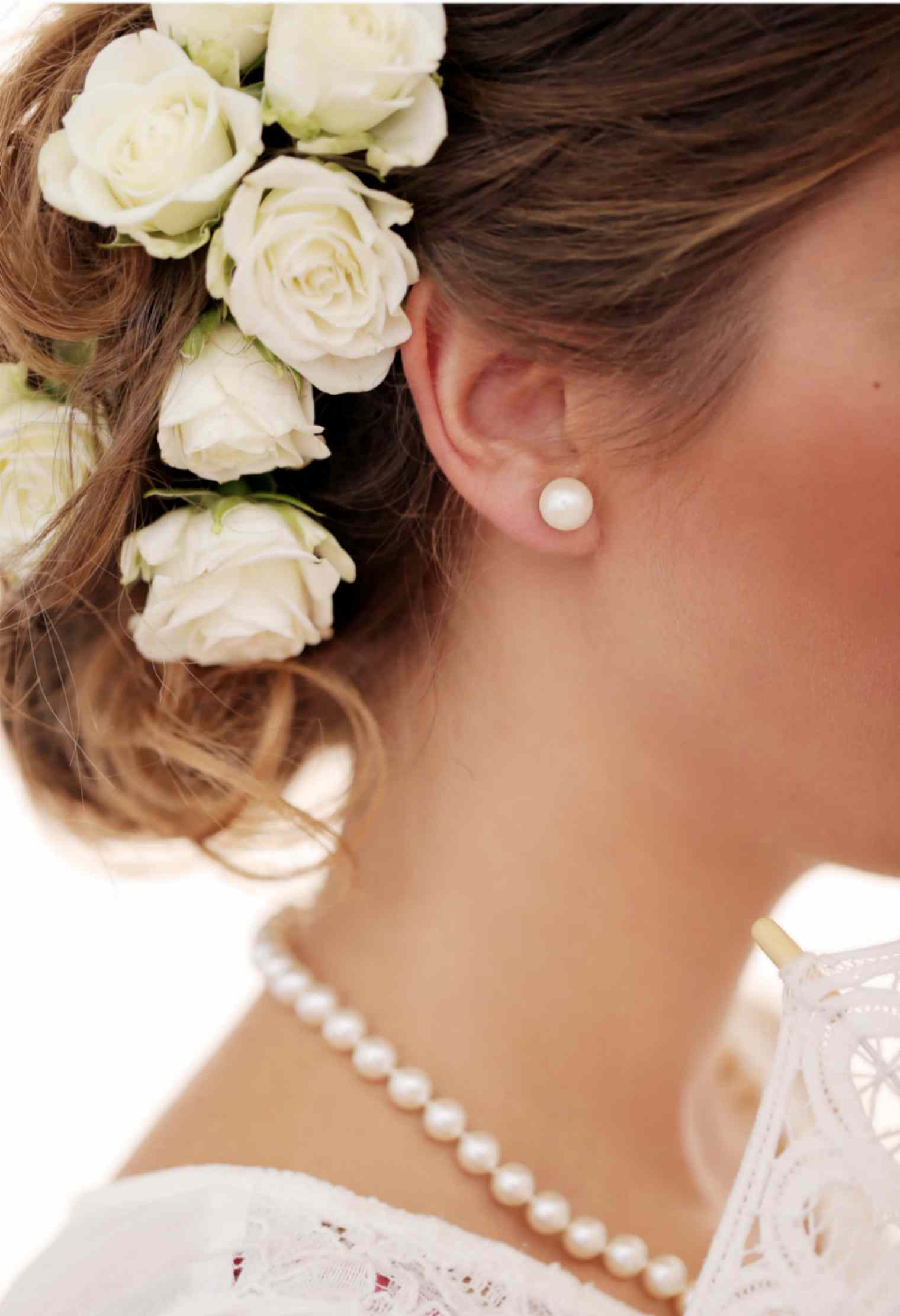 Young Women Wearing Pearl Necklace and Earrings
