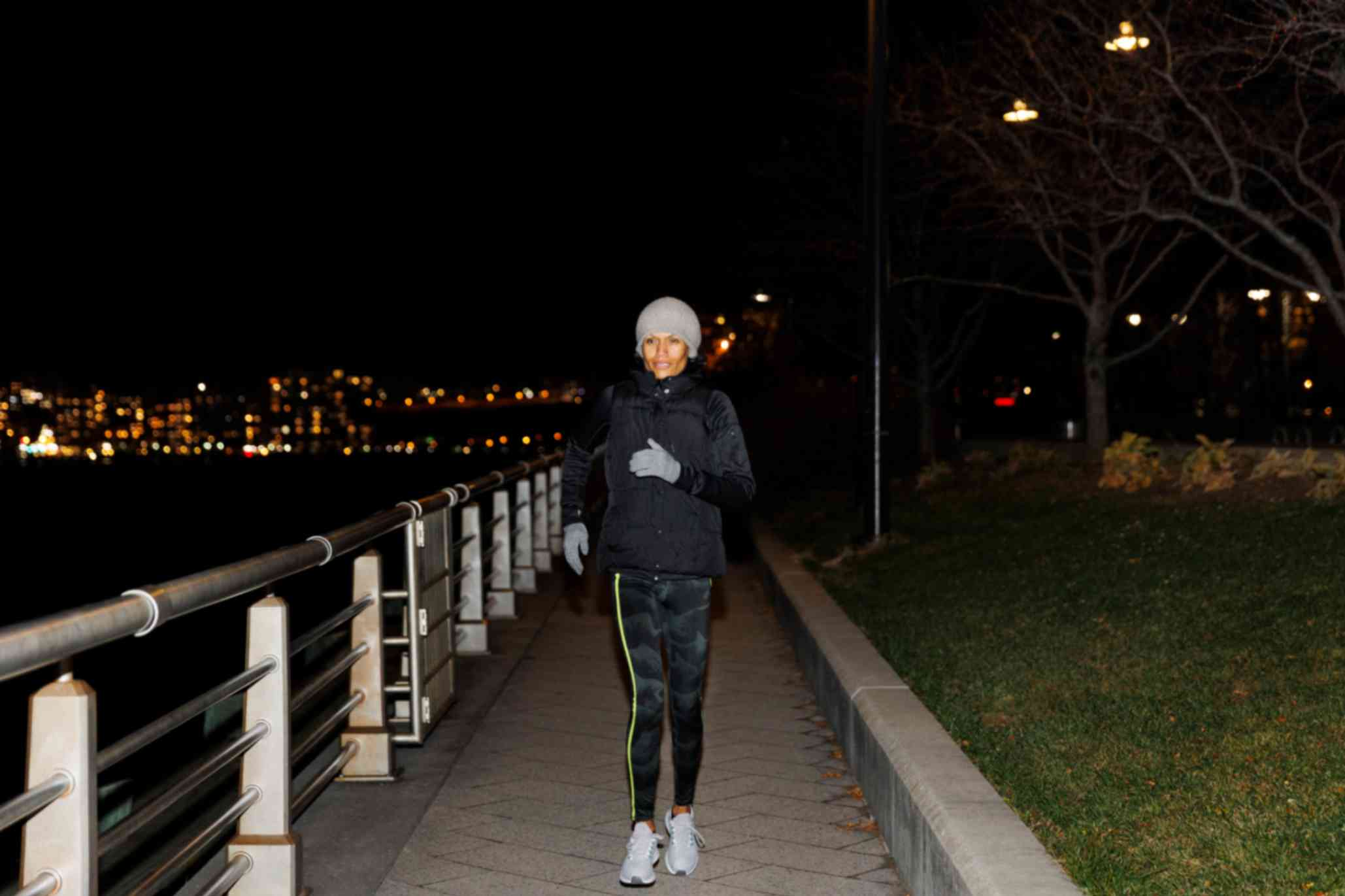 A Woman Running Late at Night in a City
