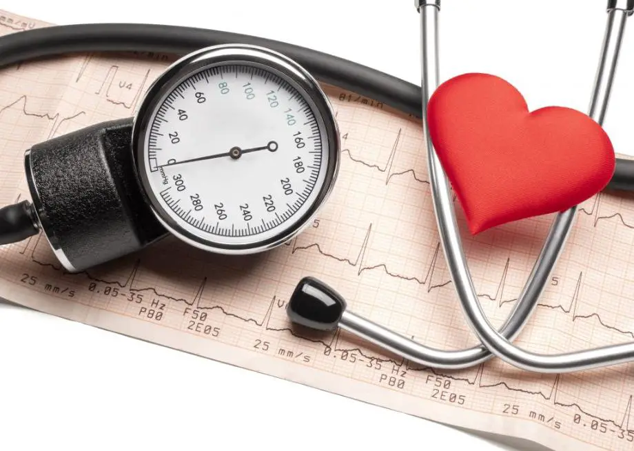 A stethoscope is placed on a graph depicting life lines, accompanied by a symbolic red heart positioned on one side.