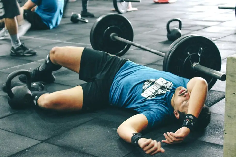  A man experiencing burnout due to excessive exercise, displaying signs of fatigue and exhaustion.
