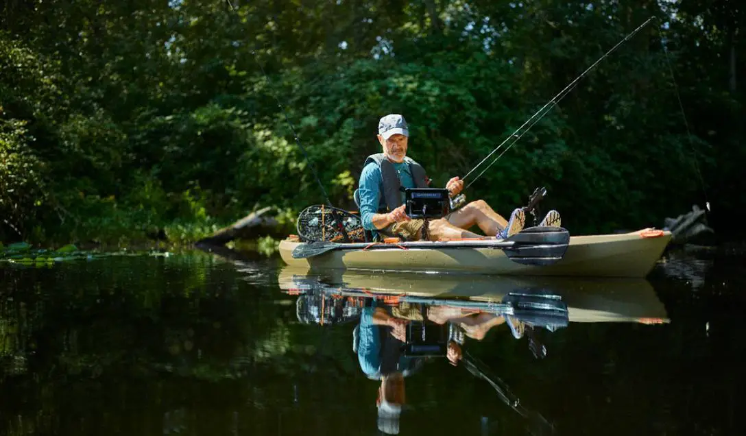 Serene scene of a man enjoying fishing while seated on a boat in a peaceful lake