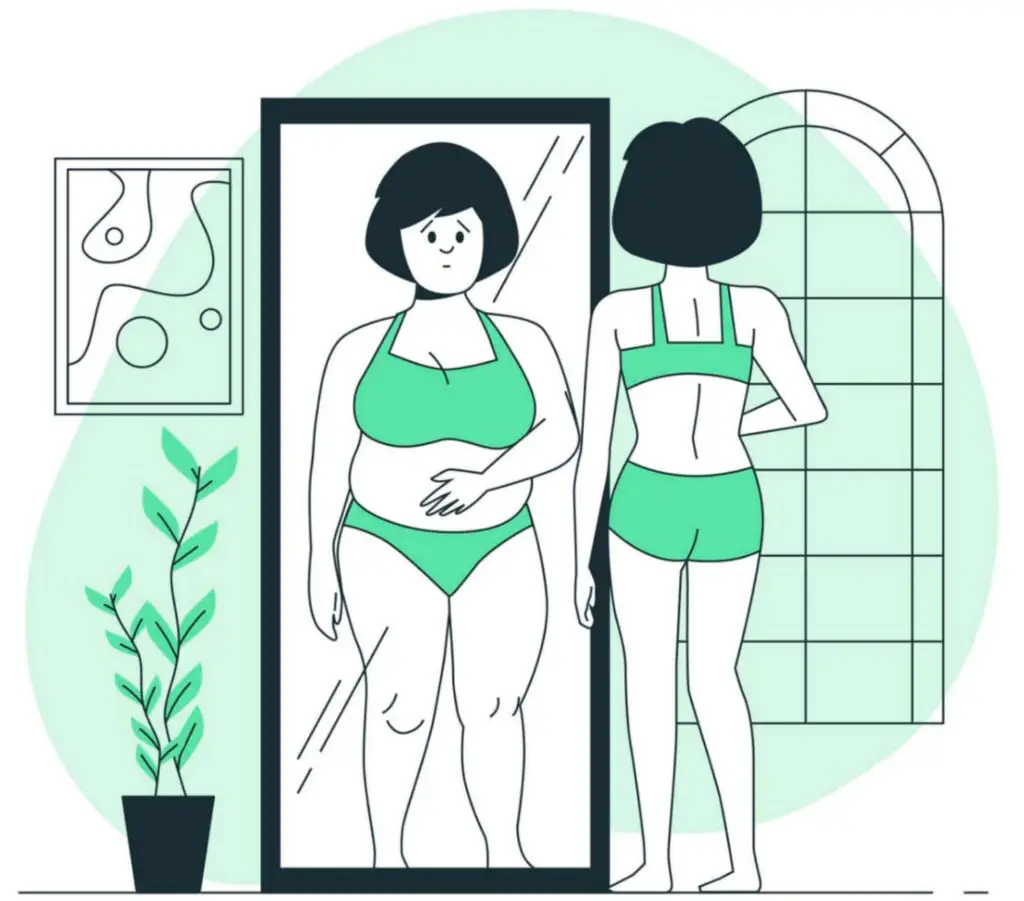 women is looking in to the mirror and considering herself fat 