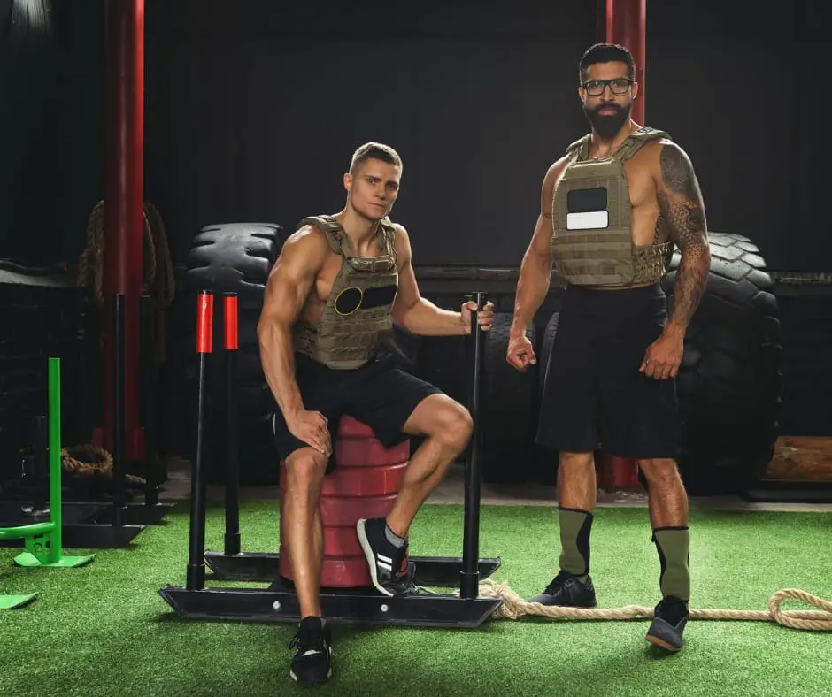 men in gym wearing weighted vests