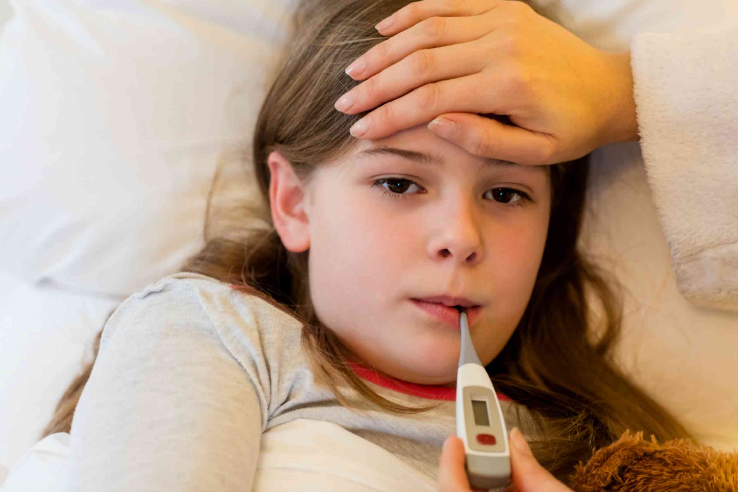 mother checking fever her daughter bedroom