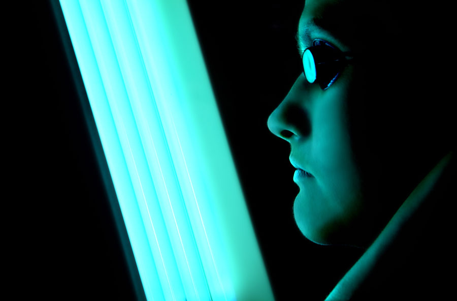 A female face exposed to the raditions from tanning bed