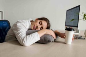 women sleeping on desk