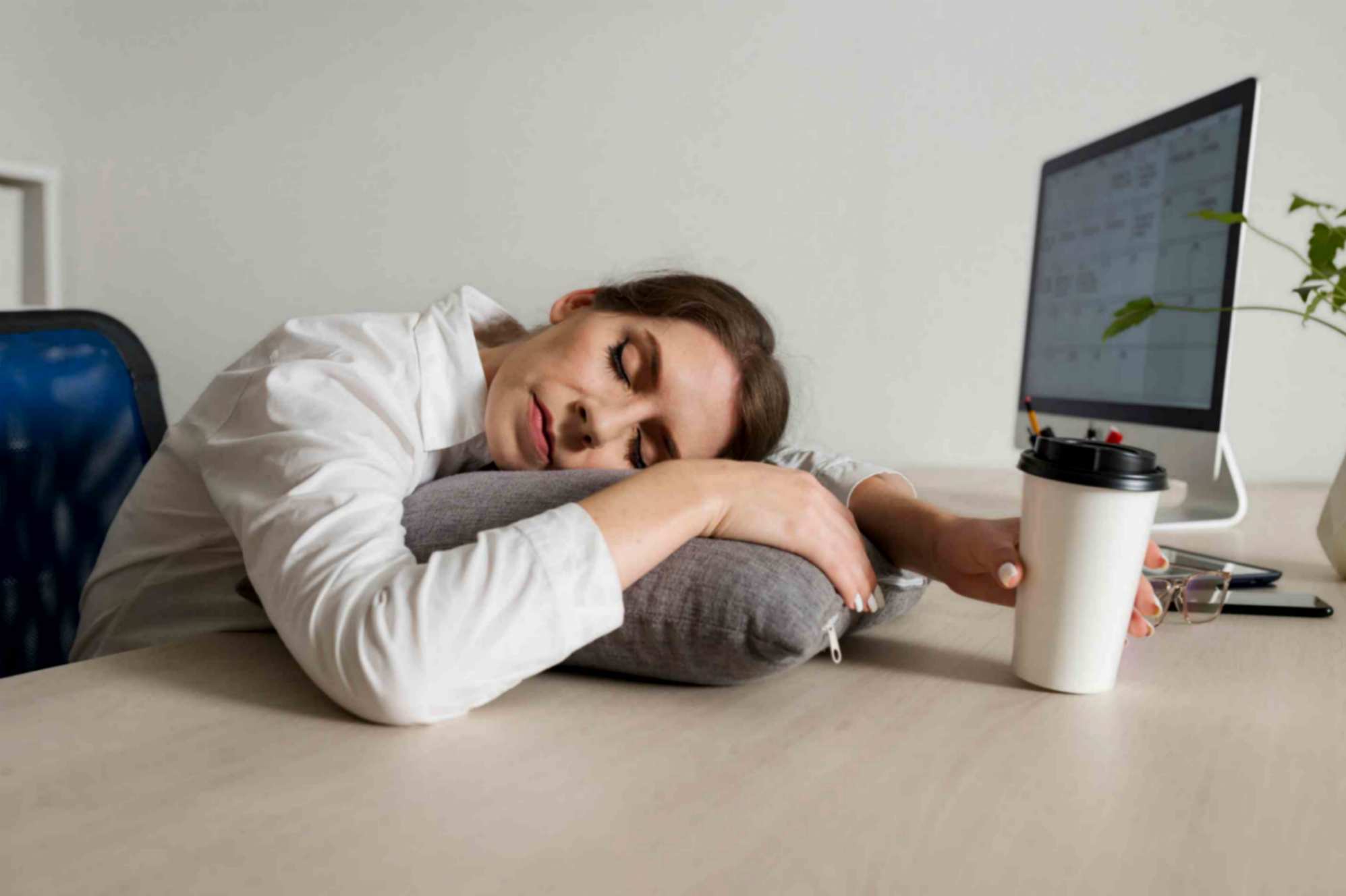 women sleeping on desk