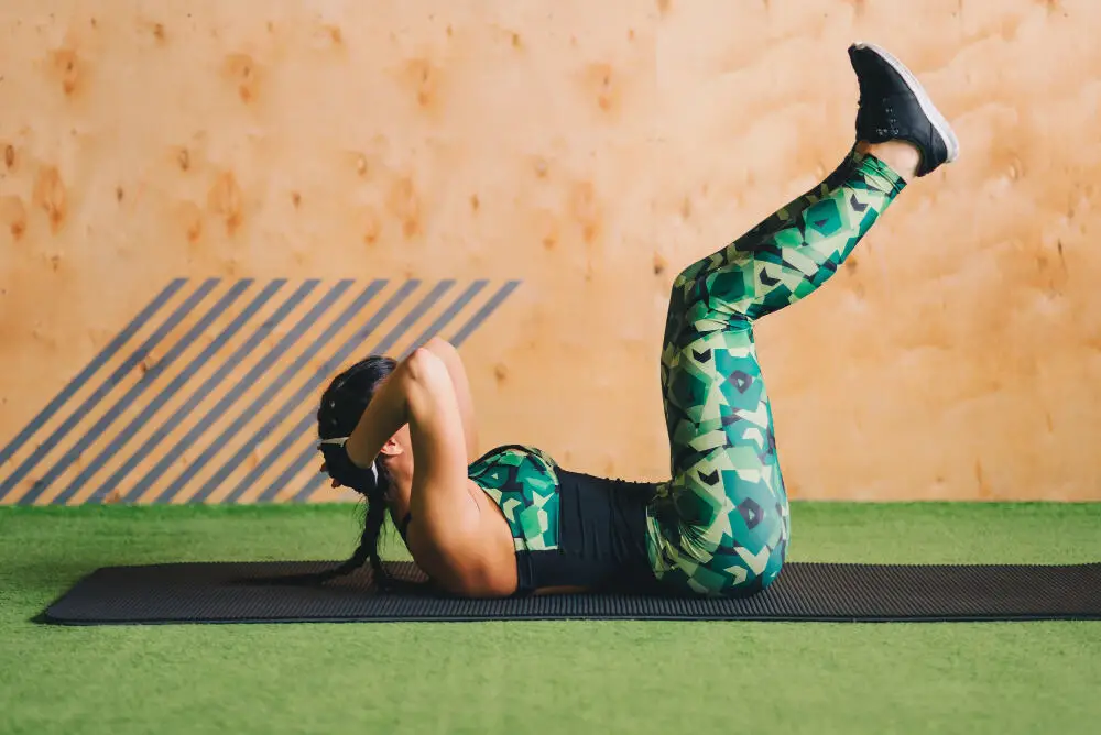young woman doing workout on Gym mat