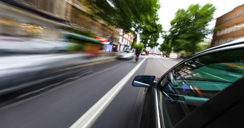 A car going super fast on a road