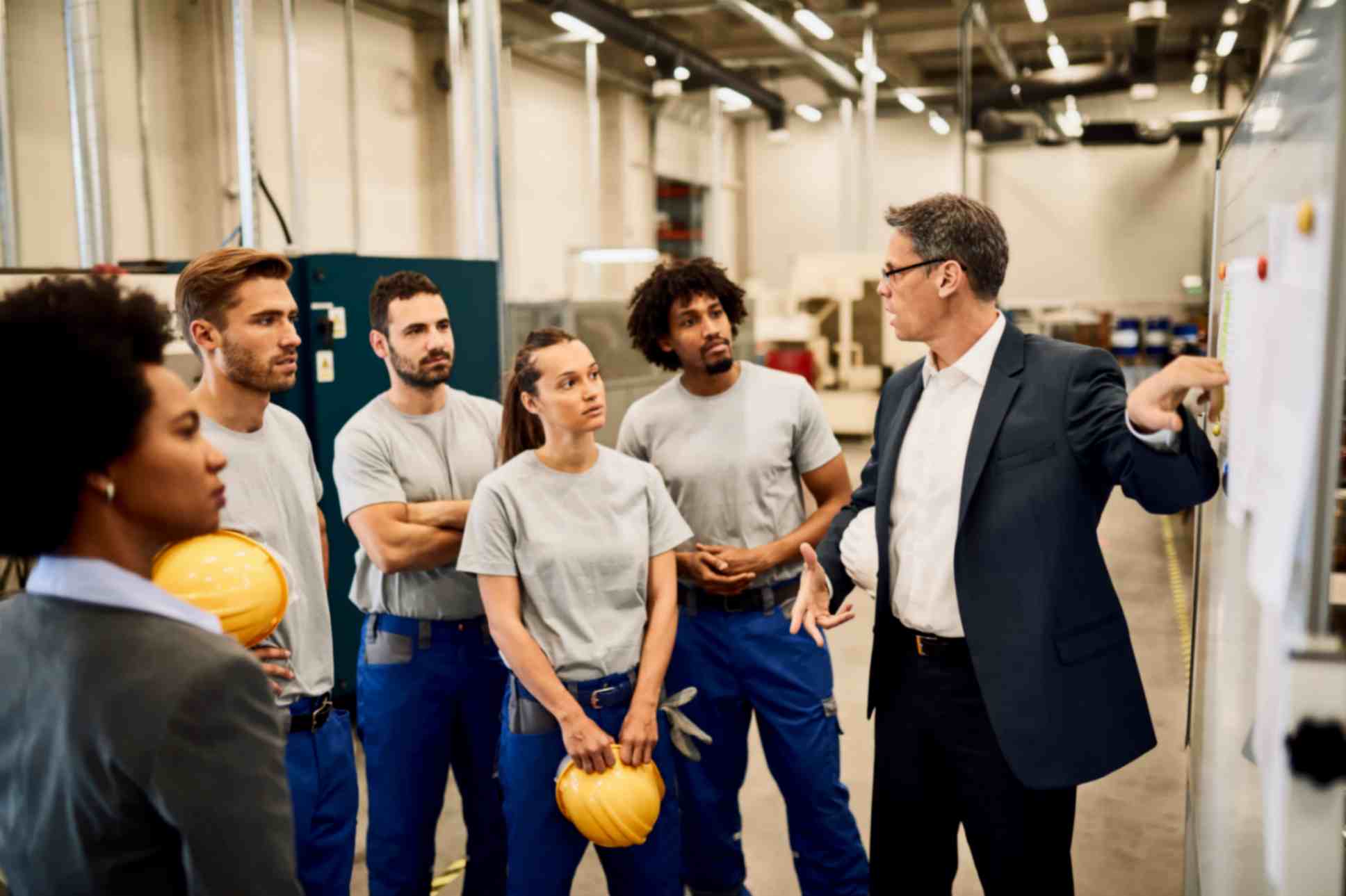 Businessman is Giving Presentation to Group of Individuals